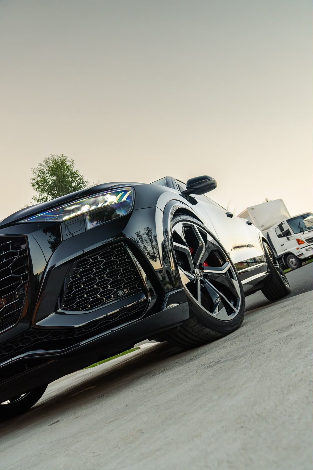 Low front angle of a black Audi Q8 with dark tinted glass