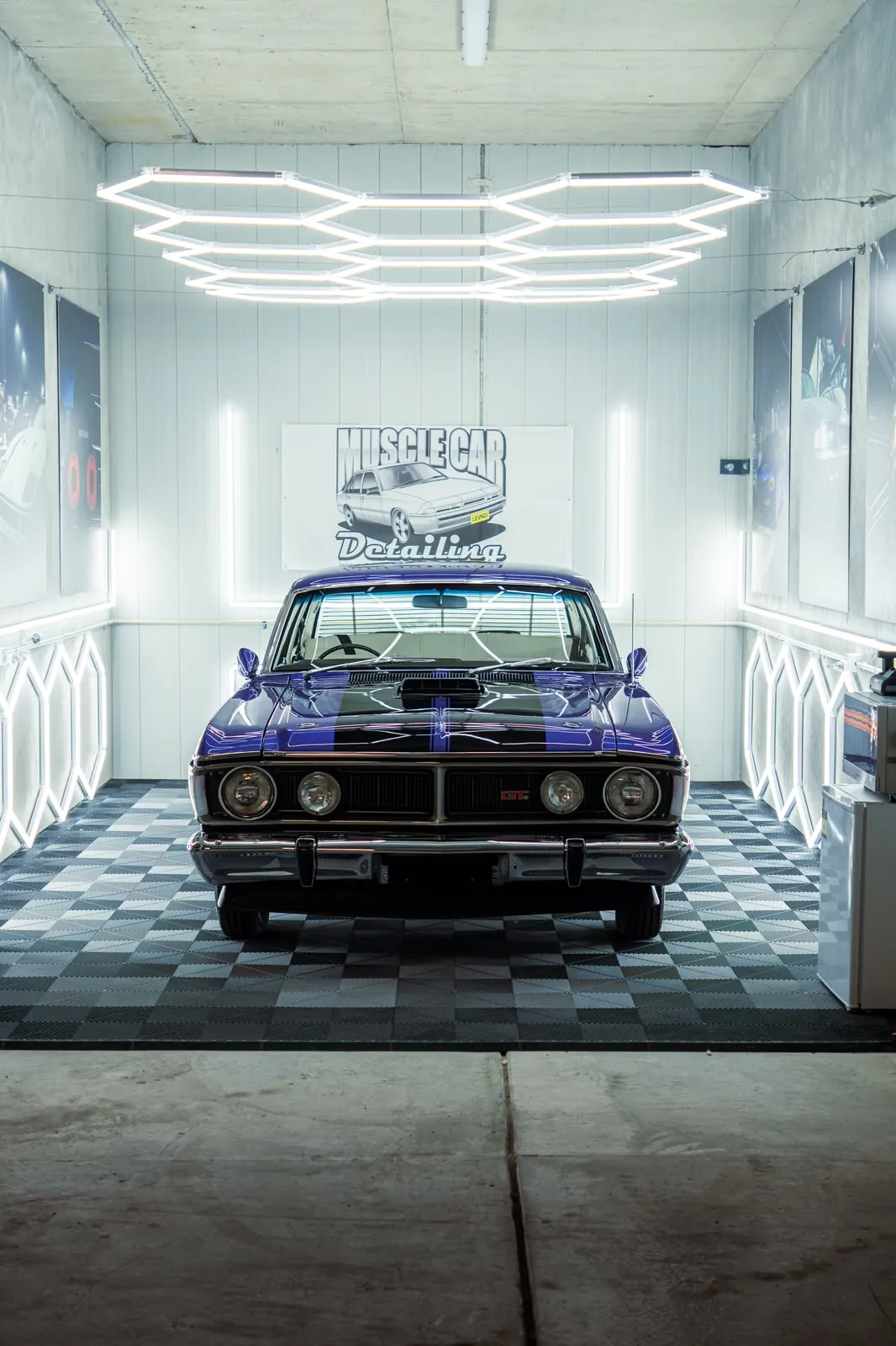 Purple Ford Falcon GT front-on under the hexagon lights in our Oran Park studio