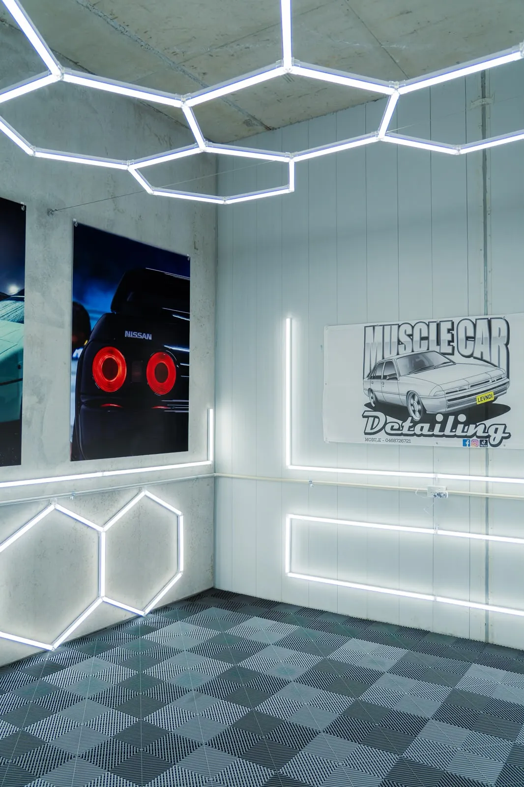 The Oran Park training studio with hexagon lights and the Muscle Car Detailing banner